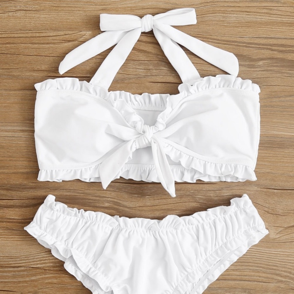 White bathing suit with ruffled ends
